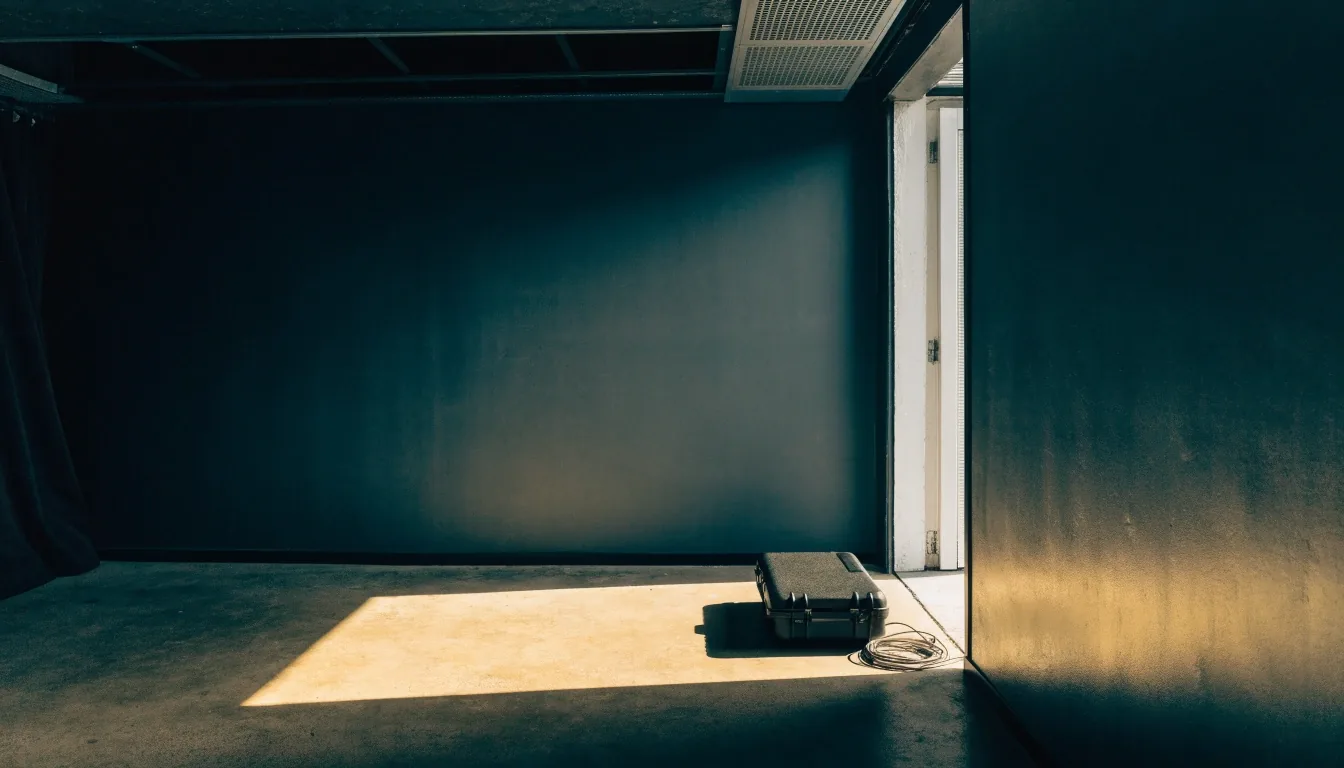 Noon light band across the studio threshold floor at ChopDawg